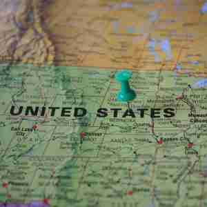 US map with a thumbtack in it